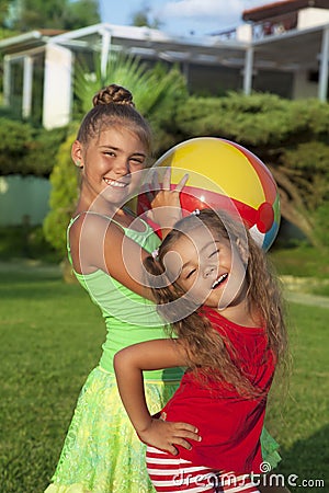 Two little girls with a ball Stock Photo
