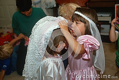 Two little girls dressing up in wedding outfits Editorial Stock Photo