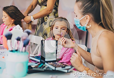 Two little girls in a make-up studio Stock Photo