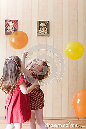 Two little girls playing with airy balls Stock Photo