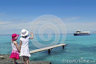 Two little girls tourist in turquoise beach Stock Photo