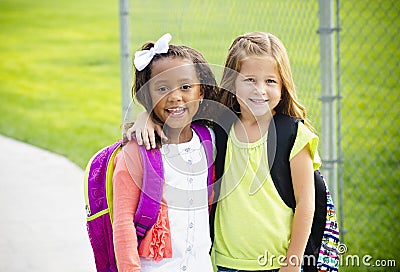 Two little kids going to school together Stock Photo