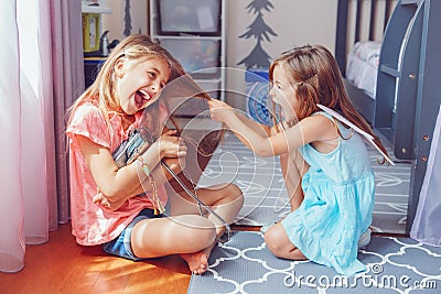 Two little mad angry girls sisters having fight at home Stock Photo