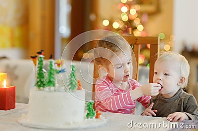 Two little sisters and a Christmas cake Stock Photo