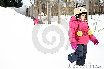 Two little twin girls are playing in the snow Stock Photo