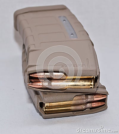 Two loaded brown .223 magazines Stock Photo