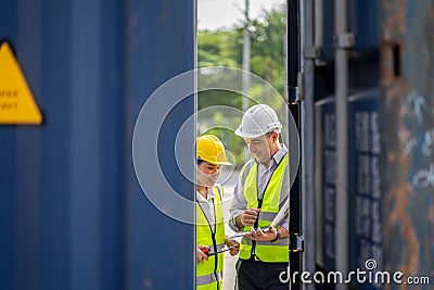 Two logistic staff checking and control loading containers box from cargo. transportation import, export logistic industrial Stock Photo