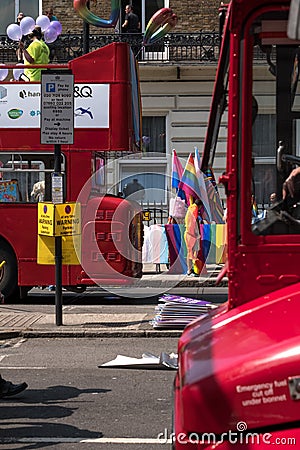 Two London double decker buses parked on Regent Street before the Gay Pride Parade 2018. Colourful LGBT rainbow flags can be seen. Editorial Stock Photo