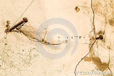 two long nails driven into a cracked wall Stock Photo