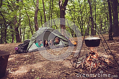 Two lovely couples lying down in the tent in a campground, so ha Stock Photo