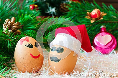 Two lovers celebrate Christmas . Unusual eggs with the muzzle. T Stock Photo