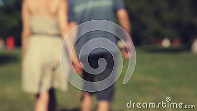 Two lovers joining hands. And walking away. Real time. Shallow depth of field Two lovers joining hands. And walking away. Real time. Shallow depth of field