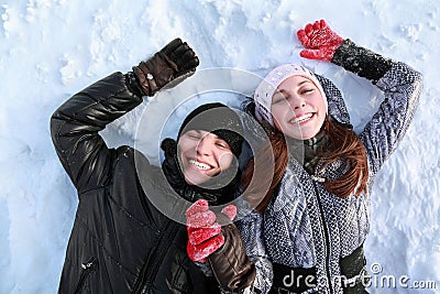 Two lovers people lie on snow Stock Photo