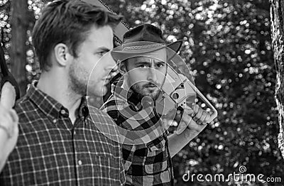 Two lumberjacks portrait with chainsaw and axe. Stock Photo