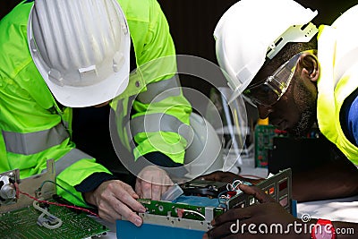 Two maintenance engineers Solar energy systems engineer perform analysis solar panels. Stock Photo