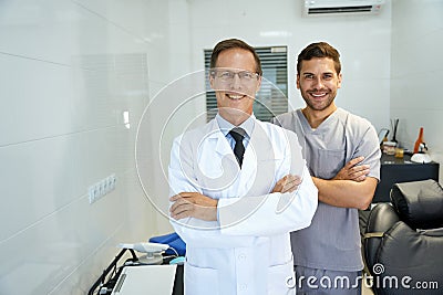 Two male dentists smiling and looking professional Stock Photo