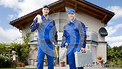 Two Male Electrician In Front Of House Stock Photo