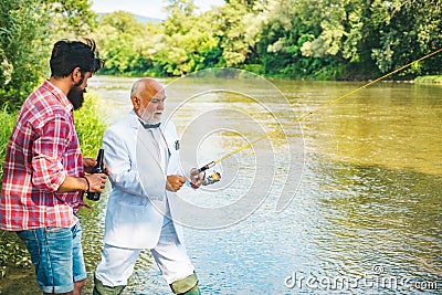 Two male friends fishing together. Fishing and drinking beer. Start living. Home of hobbies. Carry on fishing. Relax on Stock Photo