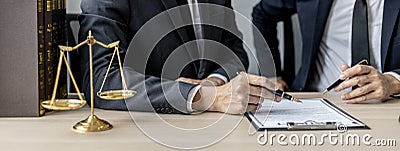 Two male lawyers are consulting together to draft a contract acknowledgment for their clients. Stock Photo