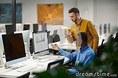 Two male managers works on computer in IT office Stock Photo