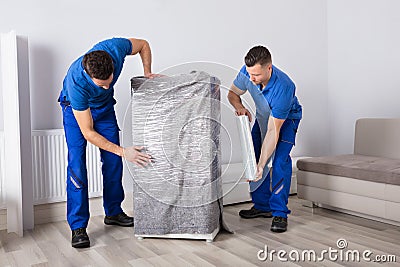 Two Male Movers Packing Furniture Stock Photo