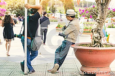 Two male photographers are waiting for customers to hire to take pictures at Dalat Flower Gardens Editorial Stock Photo