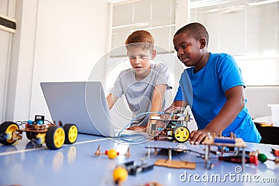 Two Male Students Building And Programing Robot Vehicle In After School Computer Coding Class Stock Photo