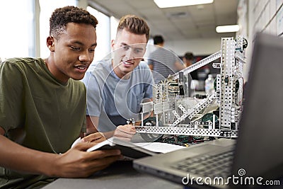 Two Male University Students Building Machine In Science Robotics Or Engineering Class Stock Photo