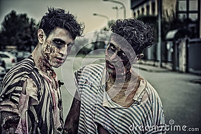 Two male zombies standing in empty city street Stock Photo