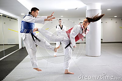 Two martial art fighters having a taekwondo combat Stock Photo