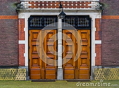 Two massive wooden doors with a lantern, Modern architecture, entrance door Stock Photo