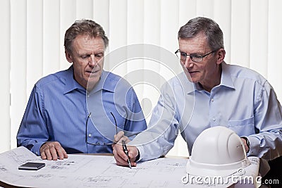 Two mature architects or engineers discussing a project Stock Photo