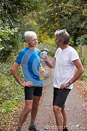 Two Mature Male Joggers Taking Break Whilst On Run Stock Photo