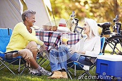 Two Mature Women Relaxing On Camping Holiday Stock Photo