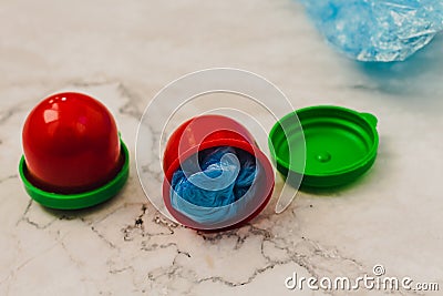 Two medical blue shoe covers in individual capsules with green\red colored caps. Disposable shoe covers. Protection concept Stock Photo