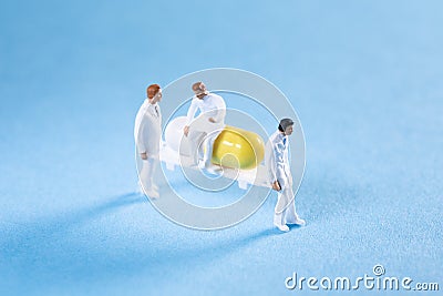 Two medics transporting a pill on a stretcher while a doctor is sitting on top Stock Photo