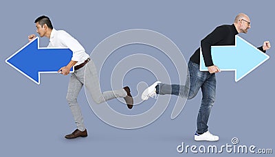 Two men with arrows and running in opposite directions Stock Photo