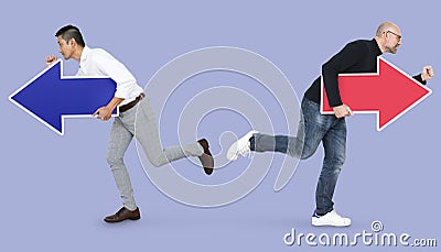 Two men with arrows and running in opposite directions Stock Photo