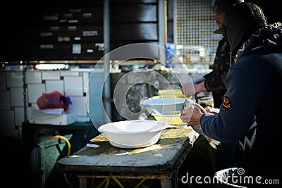 Two men cleaning fresh fish at the market Editorial Stock Photo