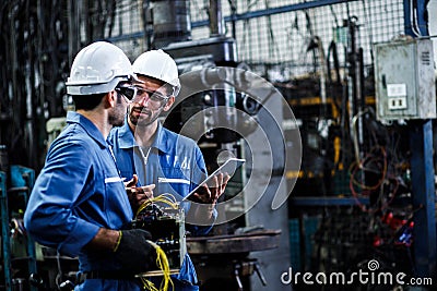 Two men engineer talking in modern factory. Stock Photo