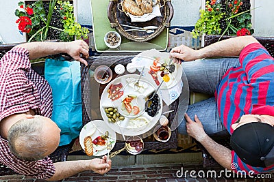 Two men having a discussion over breakfast Stock Photo