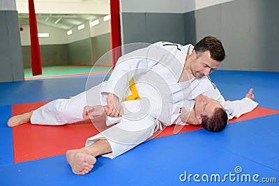 Two men on judo mat Stock Photo