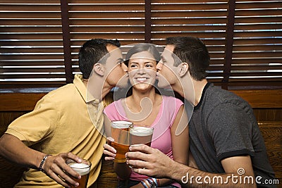 Two men kissing woman. Stock Photo