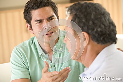 Two men in living room arguing Stock Photo