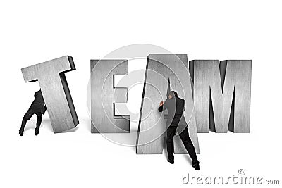 Two men moving TEAM concrete word together Stock Photo