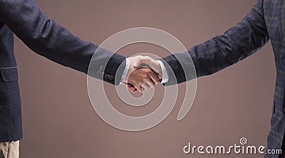 Two men in suits shake hands Stock Photo