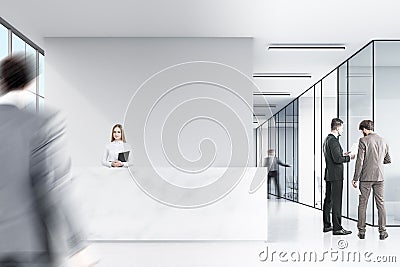 Two men in suits are talking in a corner of an office hall. Stock Photo