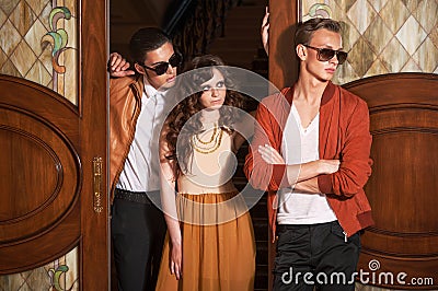 Two men and woman standing at the door Stock Photo
