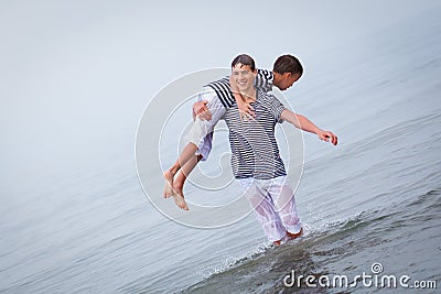 Two merry, happy, brother plays at sea Stock Photo