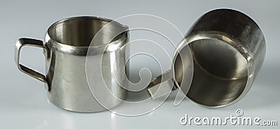 Two metal nickel-plated cups on a white background. Stock Photo